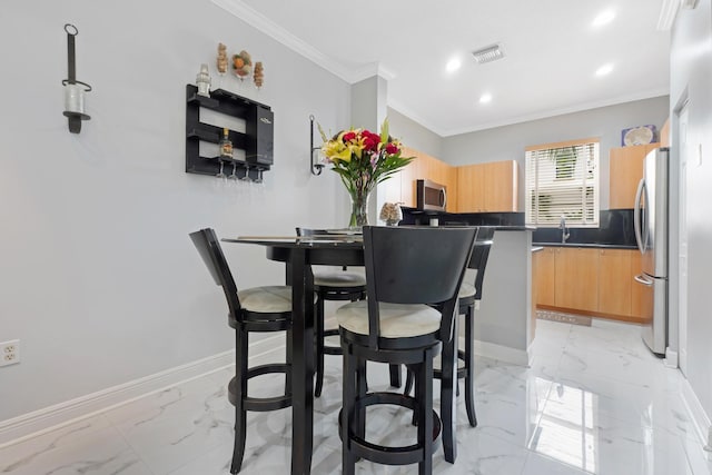 dining space with ornamental molding