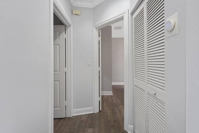 corridor with crown molding and dark hardwood / wood-style flooring