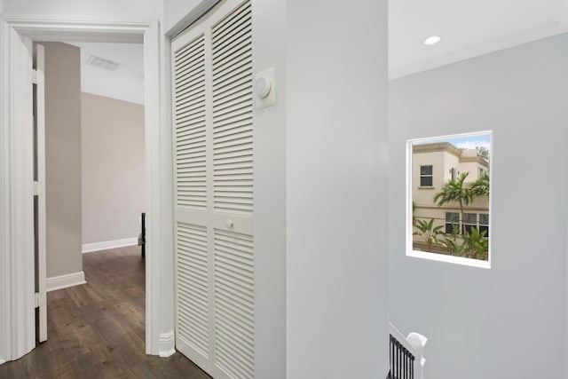 corridor with ornamental molding and dark hardwood / wood-style flooring