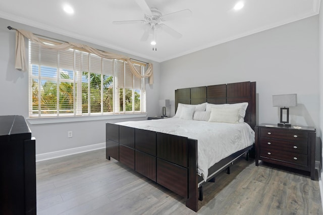 bedroom with crown molding, ceiling fan, and light hardwood / wood-style flooring