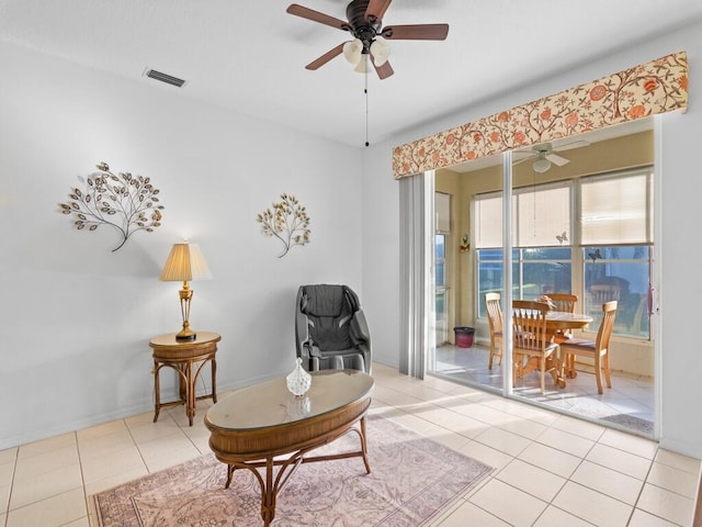 sitting room featuring ceiling fan, visible vents, and tile patterned floors