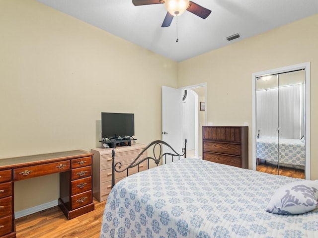 bedroom with a closet, visible vents, ceiling fan, and light wood-style flooring