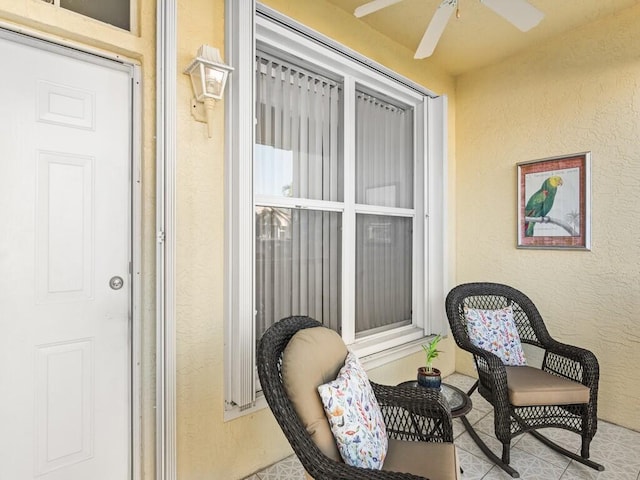 exterior space with ceiling fan and stucco siding