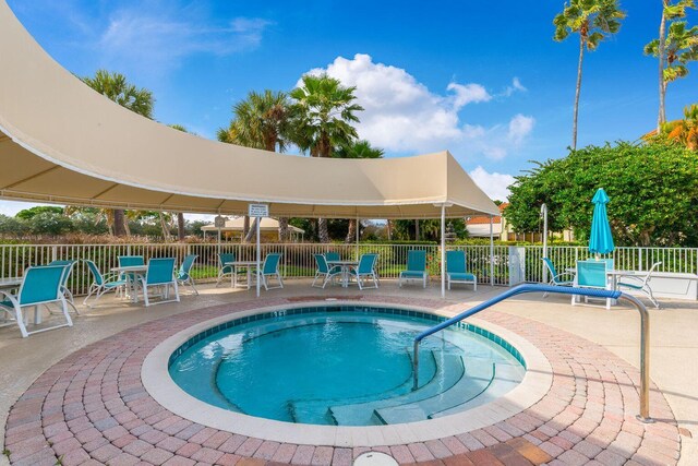 view of pool with a patio area and fence