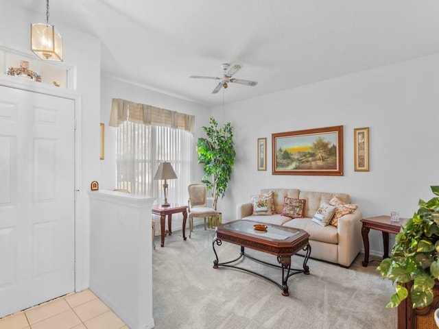 living area with ceiling fan, tile patterned flooring, and carpet flooring