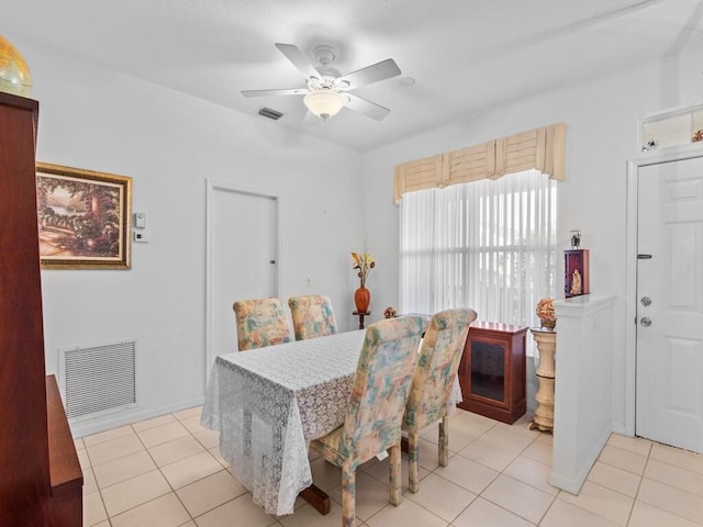 dining area with visible vents, a ceiling fan, and light tile patterned flooring