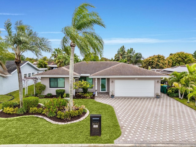 ranch-style house featuring a garage and a front yard