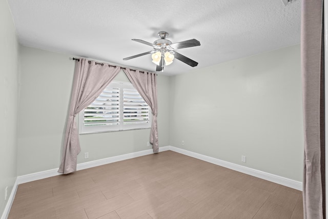 unfurnished room with a textured ceiling and ceiling fan