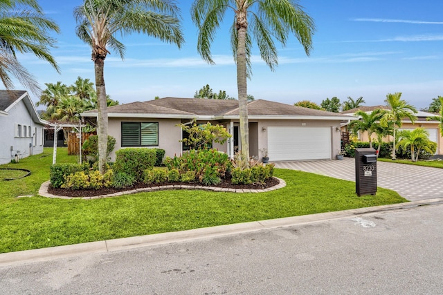 single story home with a garage and a front lawn