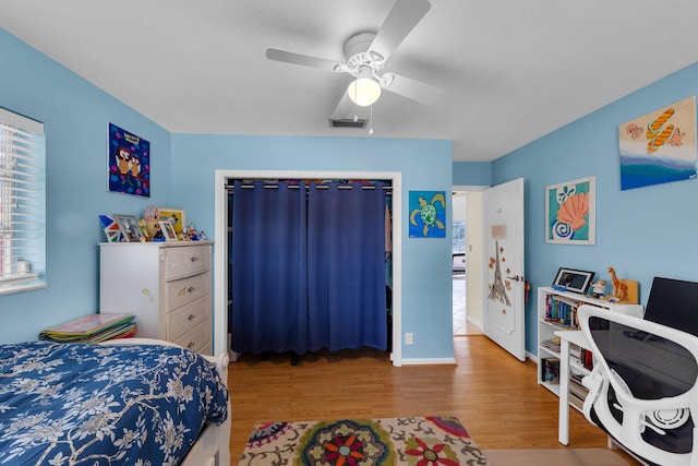 bedroom with hardwood / wood-style flooring and ceiling fan