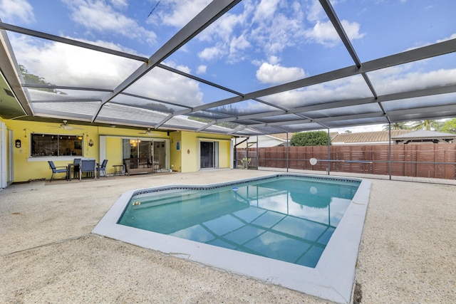 view of swimming pool with a patio and glass enclosure