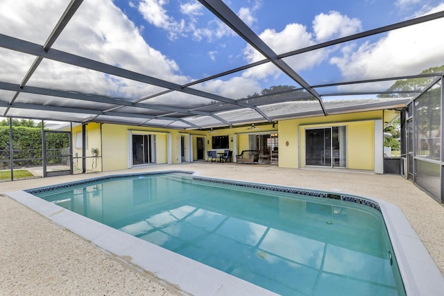 view of pool with a patio and glass enclosure