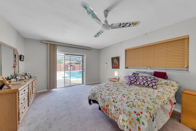 carpeted bedroom with a textured ceiling, access to outside, and ceiling fan