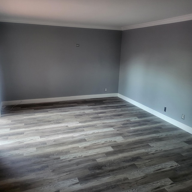 empty room featuring hardwood / wood-style floors and ornamental molding