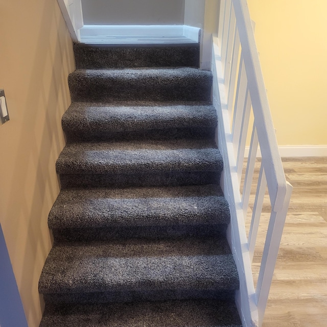 stairs with hardwood / wood-style flooring