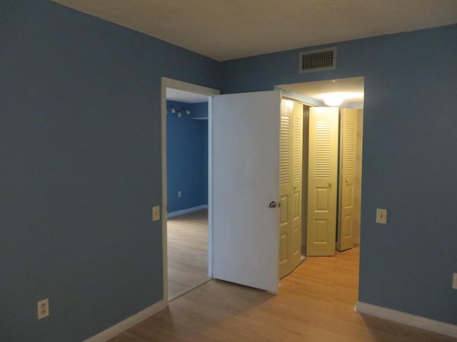 corridor with light wood-type flooring