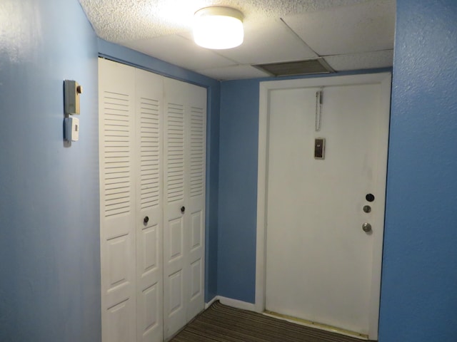 entryway featuring dark hardwood / wood-style floors and a drop ceiling