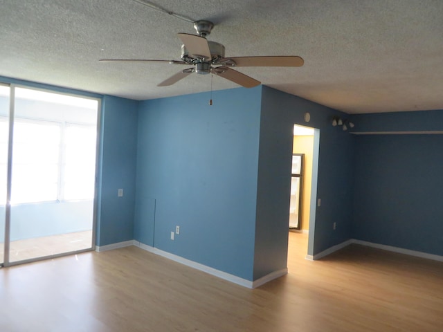 empty room featuring hardwood / wood-style flooring and a textured ceiling