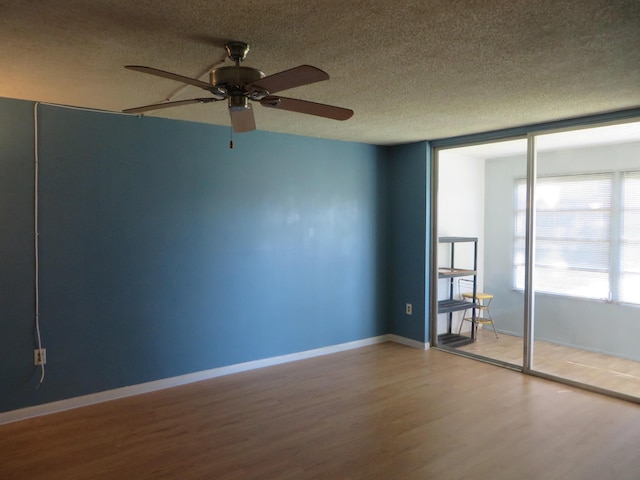 unfurnished room featuring hardwood / wood-style floors and a textured ceiling