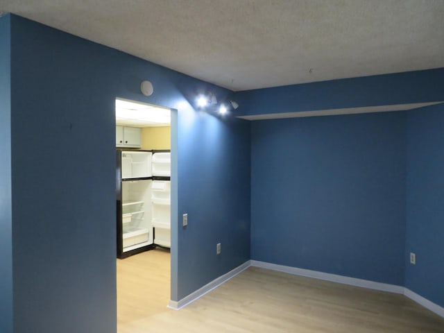 empty room featuring hardwood / wood-style floors and a textured ceiling