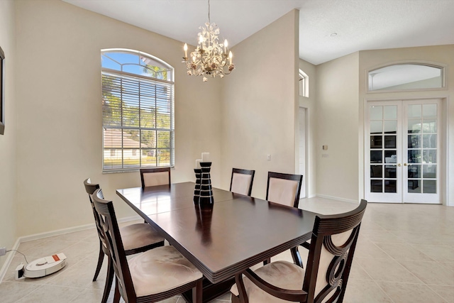 dining area with light tile patterned floors, an inviting chandelier, and french doors