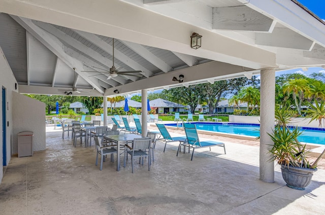 view of patio featuring a community pool and ceiling fan