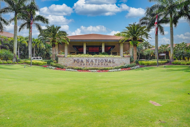 community sign featuring a lawn