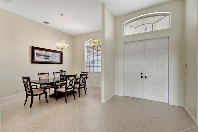 tiled foyer featuring a chandelier