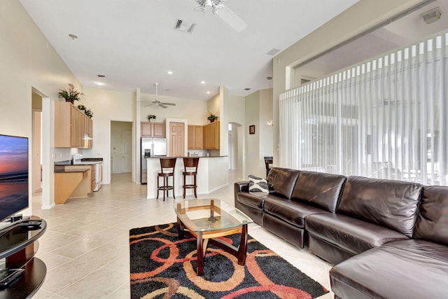 living room with light tile patterned floors and ceiling fan