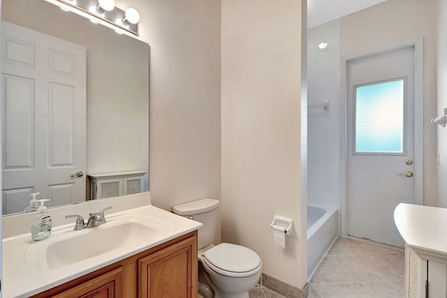 bathroom with vanity, tile patterned flooring, and toilet