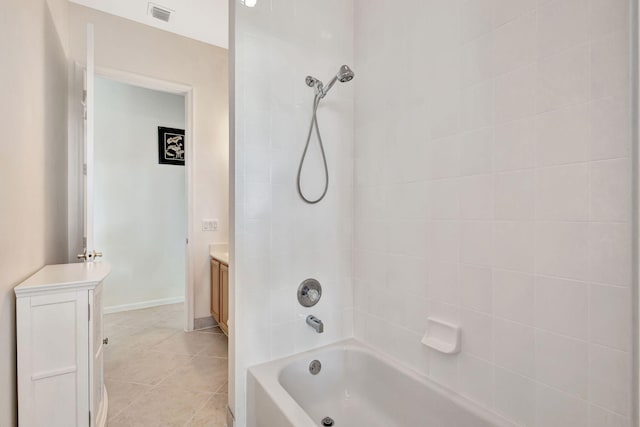 bathroom featuring tiled shower / bath, vanity, and tile patterned floors