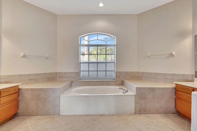 bathroom with vanity, tile patterned flooring, and a washtub