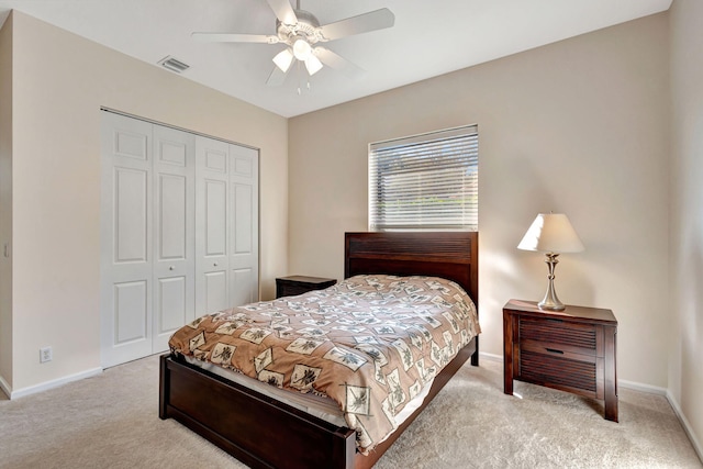 bedroom with light carpet, ceiling fan, and a closet