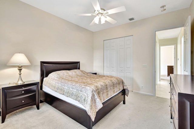 carpeted bedroom featuring a closet and ceiling fan