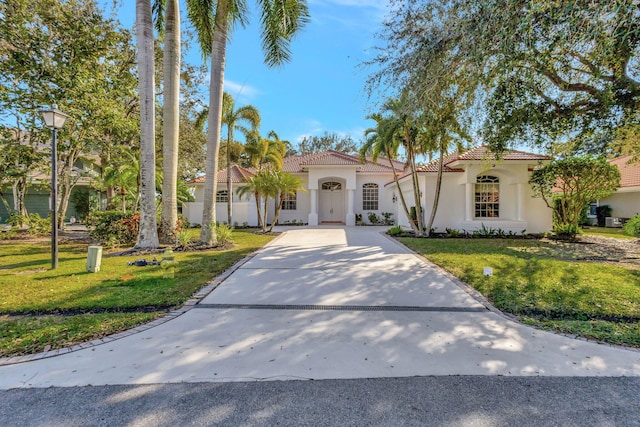 mediterranean / spanish house with a front yard