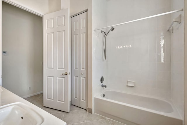 bathroom featuring tiled shower / bath, tile patterned floors, and vanity