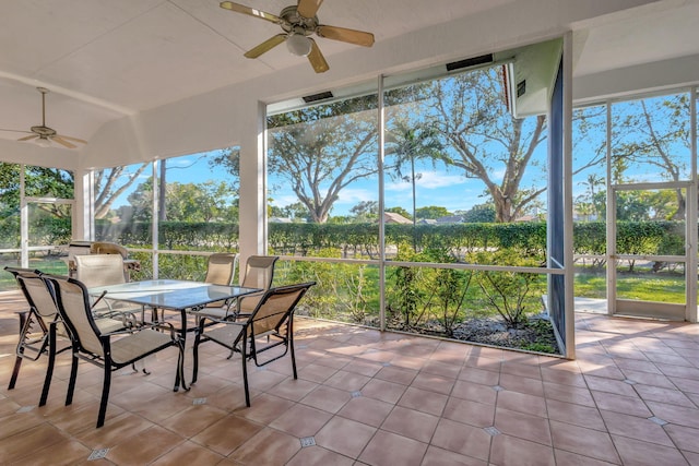 unfurnished sunroom featuring a healthy amount of sunlight and ceiling fan