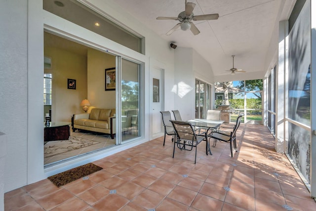 sunroom / solarium featuring lofted ceiling and ceiling fan