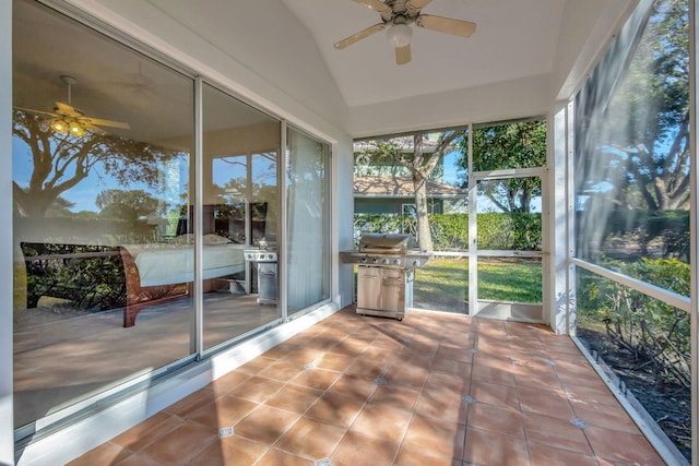 unfurnished sunroom featuring lofted ceiling and ceiling fan