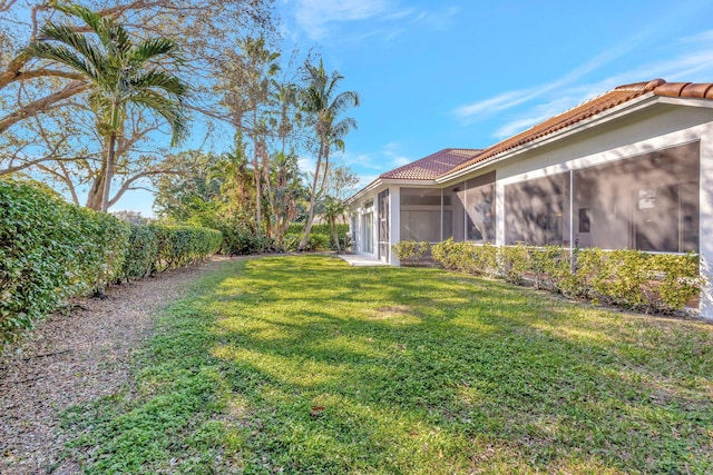 view of yard with a sunroom