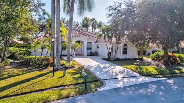 mediterranean / spanish house with a front yard