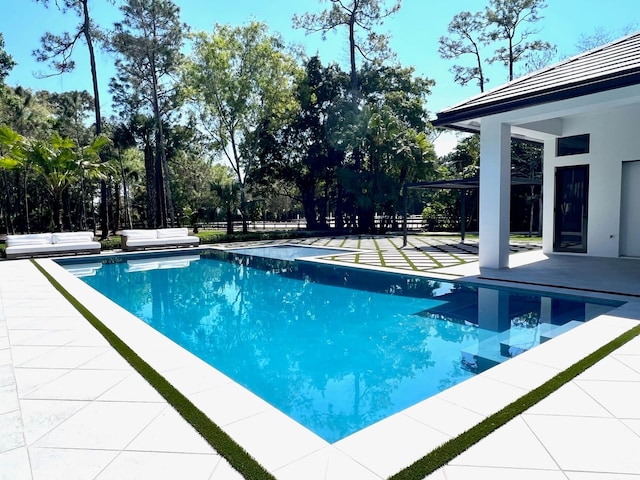 pool with a patio and fence