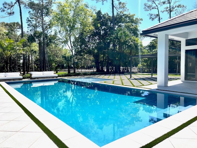 pool with a patio area and fence