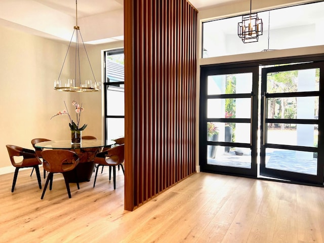 dining room with plenty of natural light, a chandelier, and wood finished floors