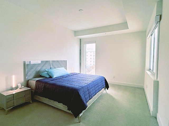 carpeted bedroom featuring multiple windows