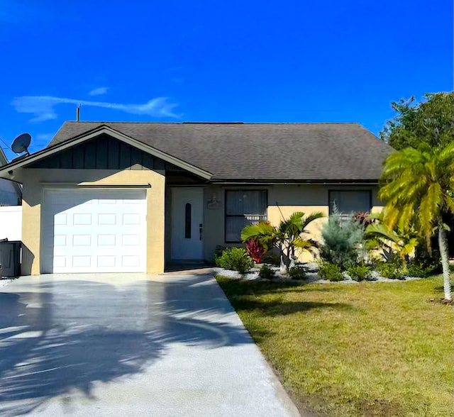 ranch-style home with a garage and a front yard