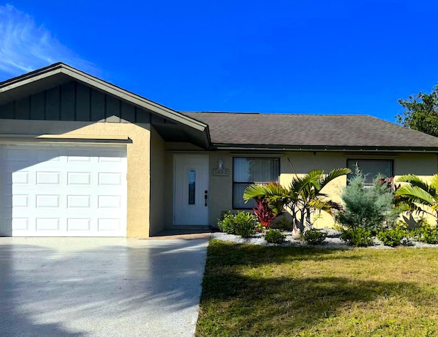 ranch-style home with a garage and a front yard