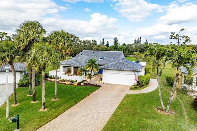 view of front of house with a garage and a front yard