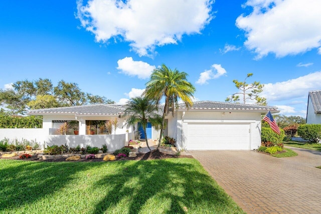 view of front of house featuring a garage and a front lawn