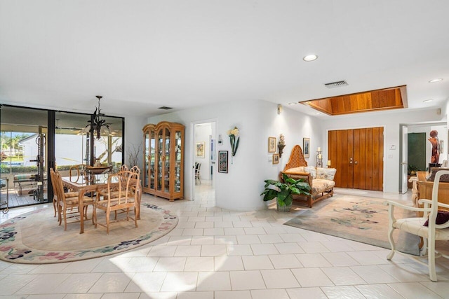 dining space featuring light tile patterned floors and floor to ceiling windows